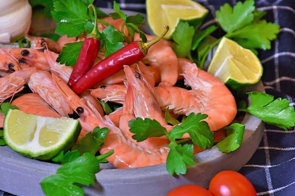 Garlic Lemon Shrimp Stir-Fry served on a white plate with lemon wedges.