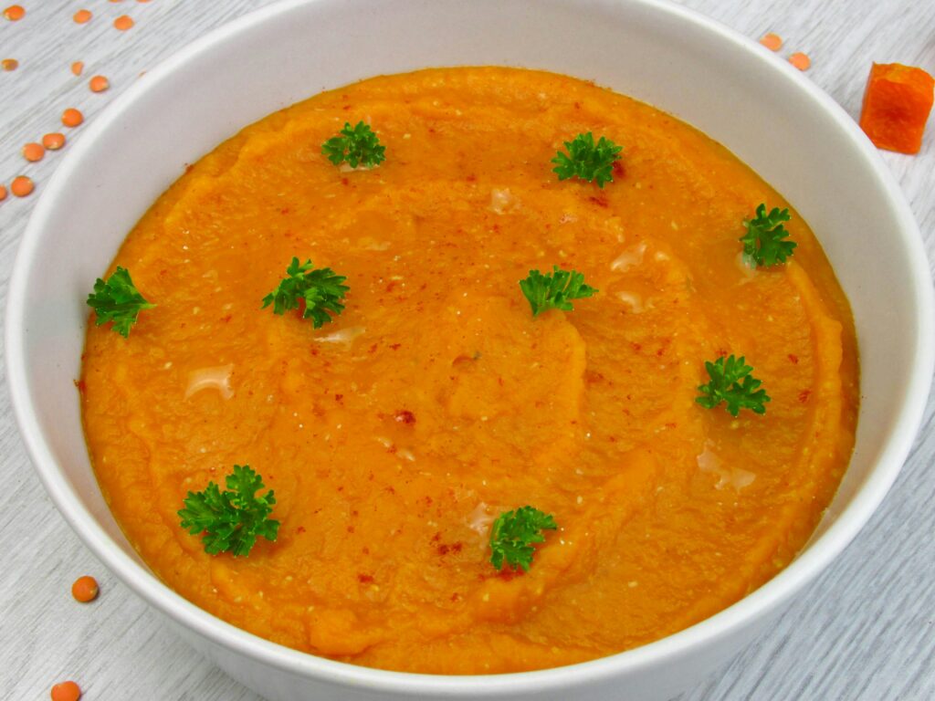 A comforting bowl of vegan lentil soup served with crusty bread.