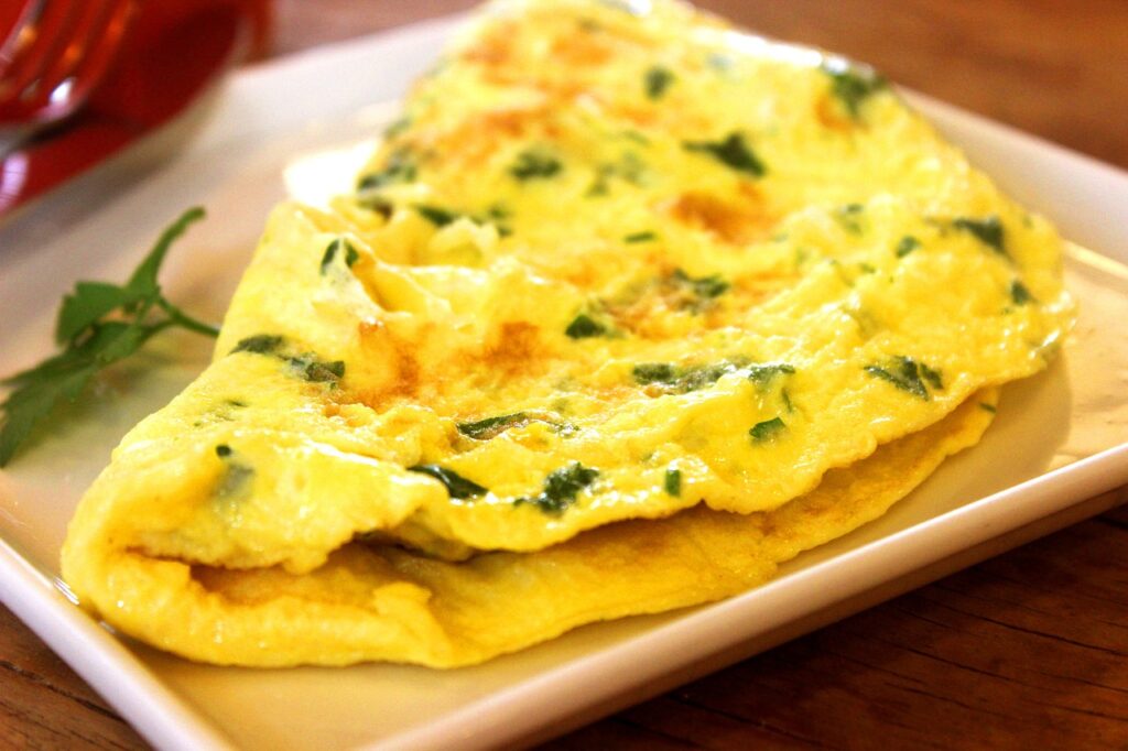 A golden omelet filled with sautéed spinach.