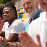 A diverse group of men enjoying outdoor activities together, representing the support and unity during Men's Mental Health Month